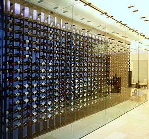 floor to ceiling wine racks behind glass case