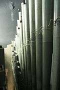 view of one of the ranks of round tapered metal pipes inside the organ.