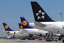 Tails of four planes on the tarmac