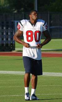  A football player jogging on a football field