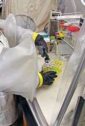 Image of researcher with chemistry equipment in laboratory