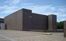 A three-quarters view of a large grey building—the State University of New York at Purchase Performing Arts Center