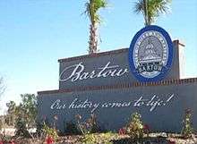  a two tiered masonry sign with Bartow and the city seal at the top and the city motto at the bottom