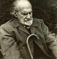 Black and white photograph of Basil Bunting, poet, in sitting position.