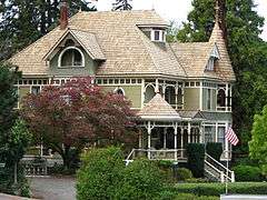 Photograph of the Bennett–Williams House, a large, turreted, two-and-a-half story house on a large, landscaped lot