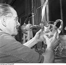 man with decorated glassware