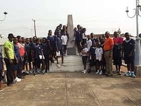 An obelisk surrounded by people