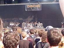 Distant photograph of a band on stage