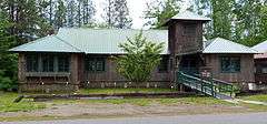 Photograph of Dover Church, a one-story, rustic building with cedar bark siding