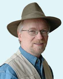 A head shot of Shawn smiling in hat.