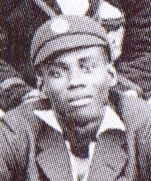A headshot of a man in a cricket cap