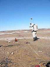 Geologist Katy Quinn of Crew 2 uses a sledge hammer to generate subsurface signals which will be detected by a geophone on Haynes Ridge on July 12, 2001.