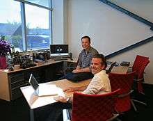 Picture of Franz von Holzhausen seated in an office with Elon Musk