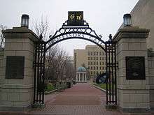 Open gateway with the letters G and W and the phrase "Professors Gate" visible on the arch