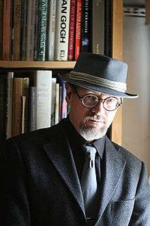 Photograph of a bearded man in a brimmed hat