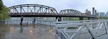 Panoramic view of a crowd of people on a bridge