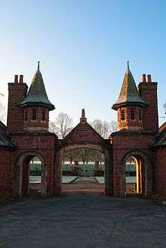 Fancy entrance with towers through houses to park