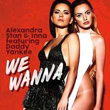 Stan and Inna posing close to each other in front of a red backdrop, sporting the outfits used for the single's music video.