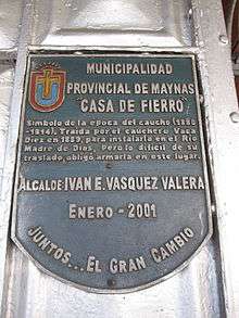 Color photograph of a commemorative plaque mounted on the exterior wall of Gustave Eiffel's Casa de Hierro, Iquitos, Peru, taken in February 2011