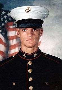 Head and shoulders of serious young man in circa 2000 U.S. Marine dress uniform.