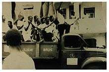 Blyden and supporters riding on the back of an open truck in 1957 election