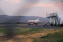 An airplane sits at a runway.