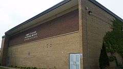 Kenner Collegiate exterior built with brown brick masonary and name mounded in metal letters.