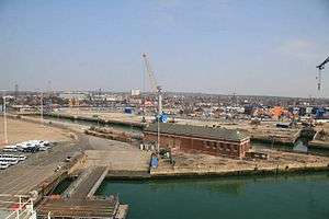 Aerial photo of large, low building with crane