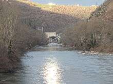 A sun reflecting on the river, with a dam 2km distant.