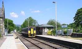 A diesel multiple unit approaches the platform