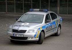 Newer-model police car, gray with blue-and-yellow markings