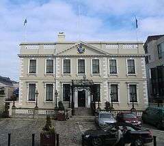 Image of building facade and associated car park.