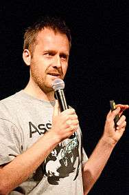 Young man in a T-shirt giving a talk