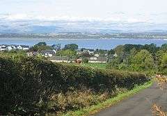 A photograph showing the village of Muirhouses in the foreground and looking north to the River Forth and Ochils in the background.