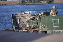 Marines crossing ribbon bridge