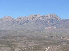 An aerial photo of the Organ Mountains from the west