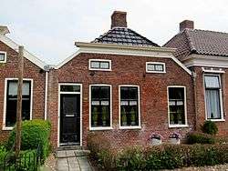 Three houses made of red bricks