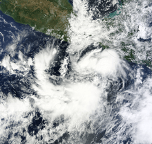 Satellite image of a weak tropical depression over open waters south of Mexico. The system features disorganized cloud cover that spirals inward toward the storm's center.