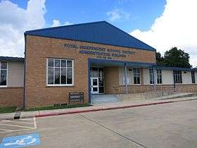 Photo shows a brick structure with a sign, Royal Independent School District Administration.