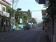 Pedro Guevara Avenue. At left is the Spanish-era Escolapia building. The bell tower of the Church of the Immaculate Conception can be seen at the background.