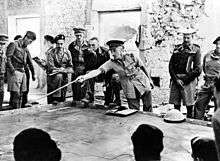 The second battle of Libya. Before zero hour. The Brigadier commanding tank units in Tobruk instructing tank commanders on the operations, using a sand table for demonstration purposes.