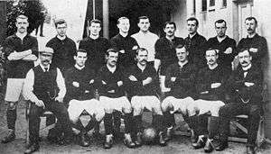 A group of footballers posing for a team photograph.