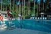 A lifeguard watching people swim in a pool