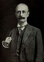 A Victorian-looking, balding moustachioed gentleman.