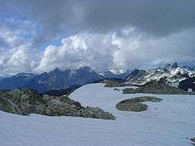 Rugged mountainous landscape with intermediate glaciation in the foreground to light glaciation in the distance.