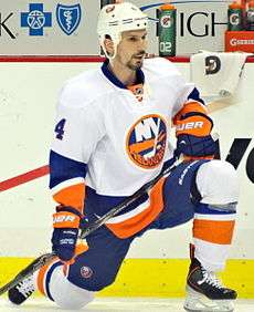 Radek Martinek stretching his legs on the ice.