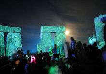 Stonehenge at night, with revellers inside