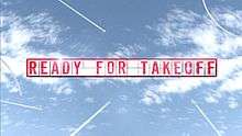 The words Ready for Take Off spelled out as seperate letters on a display board, as aircraft in the distance fly around.