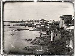 An old photograph showing buildings lining the river banks of the Rio de la Plata at Buenos Aires.