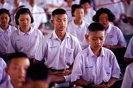 Thai school children meditating as part of organized activities at the school.